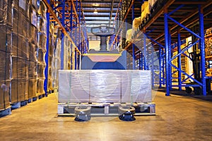 Packaging Boxes Wrapped Plastic on Pallet with Electric Forklift Pallet Jack. Tall Shelf Storage Distribution Warehouse. Shipment