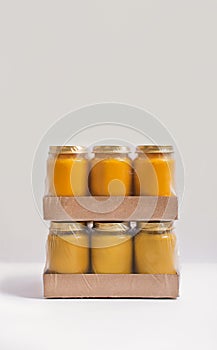 Packaging with cans of baby puree on a white background. Baby food. The first complementary food