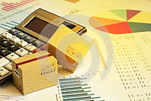 Packaging cardboard boxes with calculator and this type of financial charts include stacks of bar compare between the expansion o