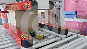 Packaging machine at workshop of food factory Process of packaging candy in foil package Factory worker Automated