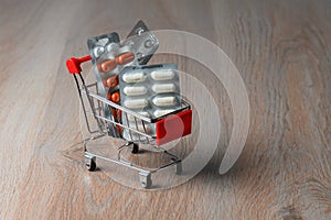 Packaging of medical tablets in the shopping cart. Purchase of medicinal tablets. Protection from virus infection