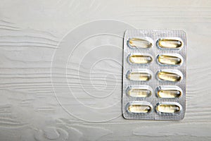 Packaging of Omega 3 capsules on a white textural background