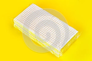 Packaging of sweet waffles on a yellow background