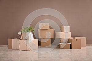 Packed carton boxes on floor near wall. Moving house concept