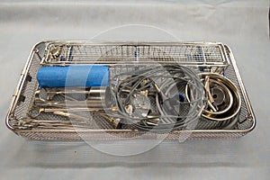 A packed instrument tray for performing a urological resection is open in the operating room