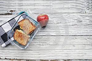 Packed Lunch of homemade Toasted Egg Sandwich and Apple