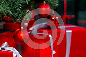 Packed red gifts boxes under the Christmas tree