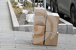 packed things in cardboard boxes are on the sidewalk. Preparation for loading or unloading of products
