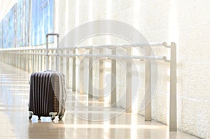 Packed travel suitcase, airport. Summer holiday and vacation concept. Traveler baggage, brown luggage in empty hall