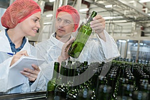 Packers working on bottling line at manufacture photo