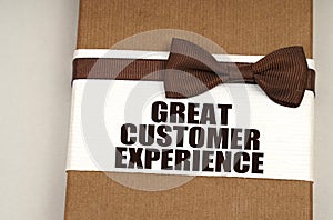 On the packing box with a bow-tie the inscription - Great Customer Experience