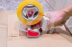 Packing the box with scotch tape dispenser