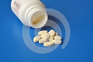 Packing of pills on a blue background. Vitamins closeup.