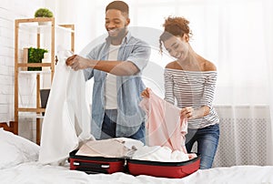 Packing suitcase. Happy couple preparing for travel