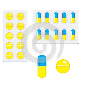 Packing yellow blue and yellow capsule pills on white background.