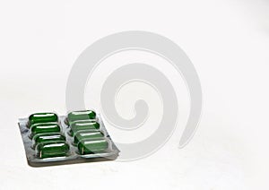 Packs of green pills isolated on white photo
