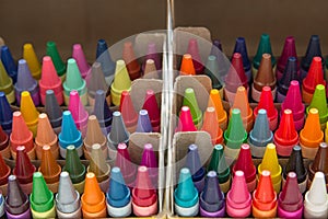 Packs of multi-colored crayons in a box