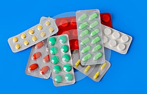 Packs of pills on blue background