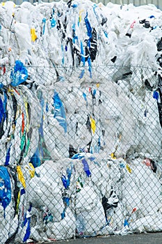 Packs and Stocks of Wrapped Scrap Plastic Dedicated for Eco Recycling in front of a Recycling Factory