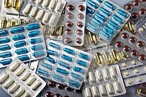 packs of tablets and pills in white yellow blue and brown color