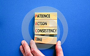 PACT patience action consistency time symbol. Concept words PACT patience action consistency time on blocks on blue background.