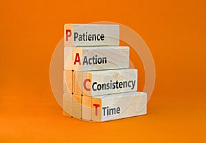 PACT patience action consistency time symbol. Concept words PACT patience action consistency time on blocks on orange background.