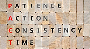 PACT patience action consistency time symbol. Concept words PACT patience action consistency time on blocks on wooden background.