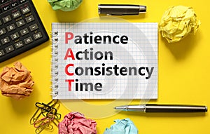 PACT patience action consistency time symbol. Concept words PACT patience action consistency time on white note, yellow background