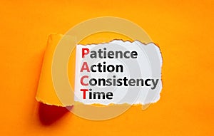 PACT patience action consistency time symbol. Concept words PACT patience action consistency time on white paper, orange