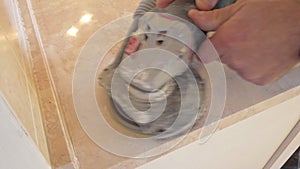 Pad sander tool sanding a kitchen top