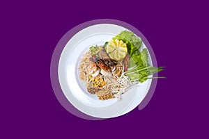 Pad thai. Asian Thai food on white plates with purple background