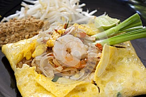 Pad Thai, fried noodles with shrimps in Omelet