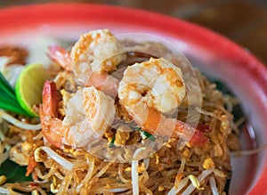 Pad thai or Pud Thai  fried noodle thai style with prawns Thai street fast food traditional