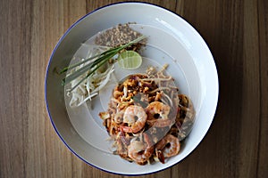 Pad thai with shrimp on wooden table , Thai food