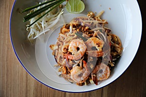 Pad thai with shrimp on wooden table , Thai food