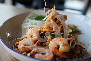 Pad thai with shrimp on wooden table , Thai food