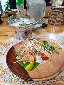 Pad thai soup ingridients fried noodles stier lime pepper chilli spouse cooker wood plate chiang mai thai food cooking