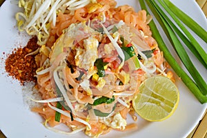 Pad Thai stir fried rice noodle with egg and vegetable on dish