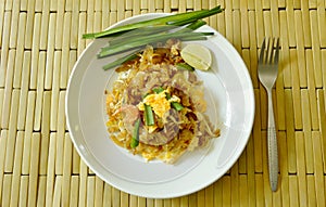 Pad Thai stir fried rice noodles with dry shrimp and egg on plate