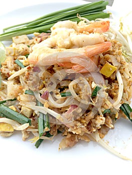 Pad Thai, stir-fried rice noodles with shrimp in white dish on white background. The one of Thailand's national main dish. th