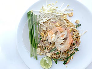 Pad Thai, stir-fried rice noodles with shrimp in white dish on white background. The one of Thailand's national main dish. th