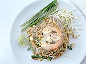 Pad Thai, stir-fried rice noodles with shrimp in white dish on white background. The one of Thailand's national main dish. th