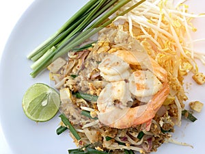 Pad Thai, stir-fried rice noodles with shrimp in white dish on white background. The one of Thailand's national main dish. th