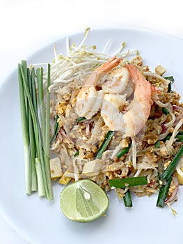 Pad Thai, stir-fried rice noodles with shrimp in white dish on white background. The one of Thailand's national main dish. th