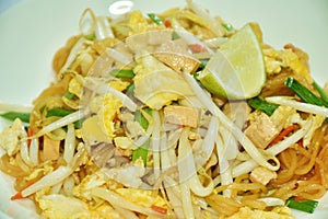 Pad Thai stir fried rice noodles with tofu and egg couple bean sprout on plate