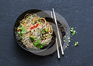 Pad Thai vegetarian vegetables udon noodles in a dark background, top view. Vegetarian food in asian style.