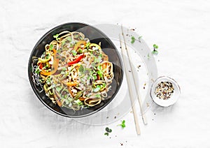 Pad Thai vegetarian vegetables udon noodles in a light background, top view. Vegetarian food