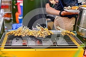 Padang Sate is on a yellow grill