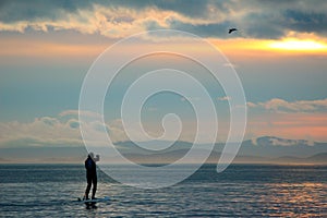 Paddle boarder at sunset