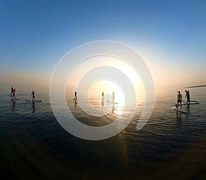 Paddle Boarders At Sunrise